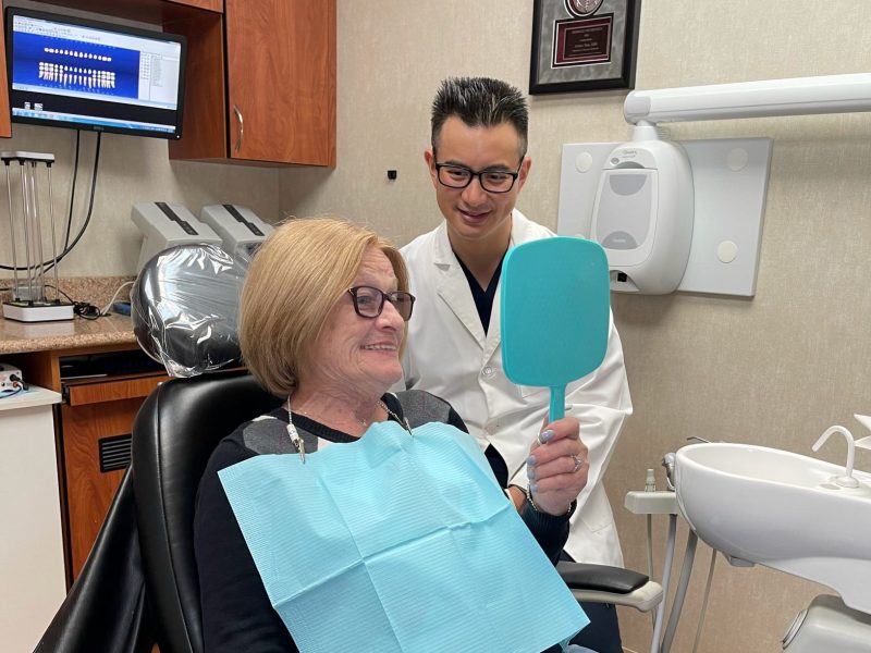 Patient examining new dentures
