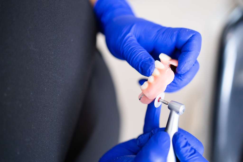 dentist crafting dental prosthetic