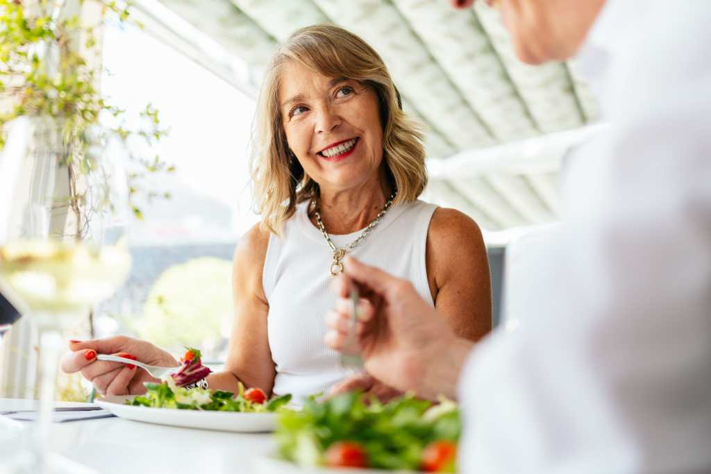 senior woman enjoying healthy salad friend